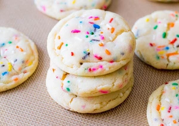 stack of funfetti sugar cookies on a silpat baking mat